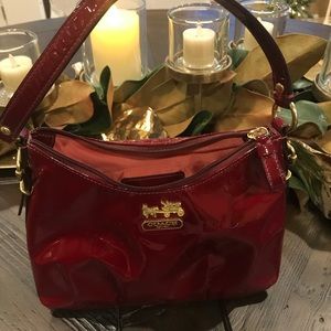 Small crimson patent leather Coach purse